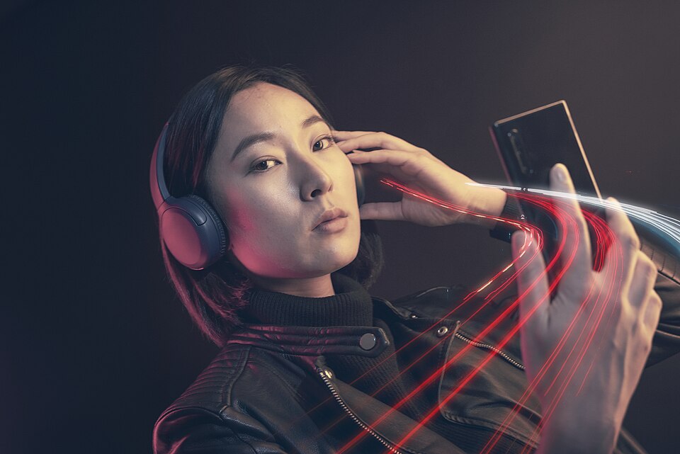 A listener playing music on a smartphone